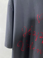 Balenciaga dark navy T-shirt sleeve with red cursive script print, cropped view