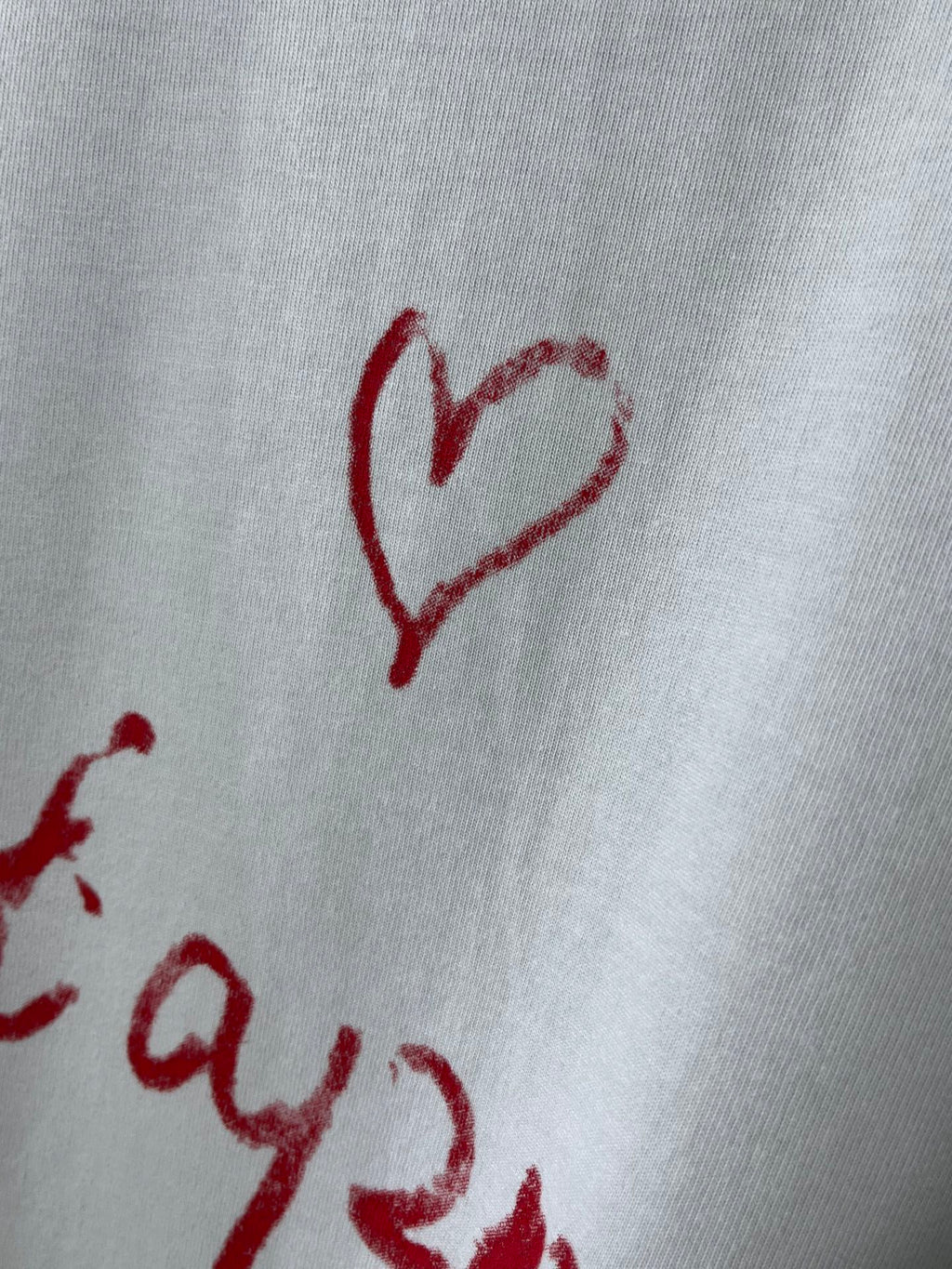 Balenciaga short-sleeve T-shirt close-up of red heart graphic on white fabric