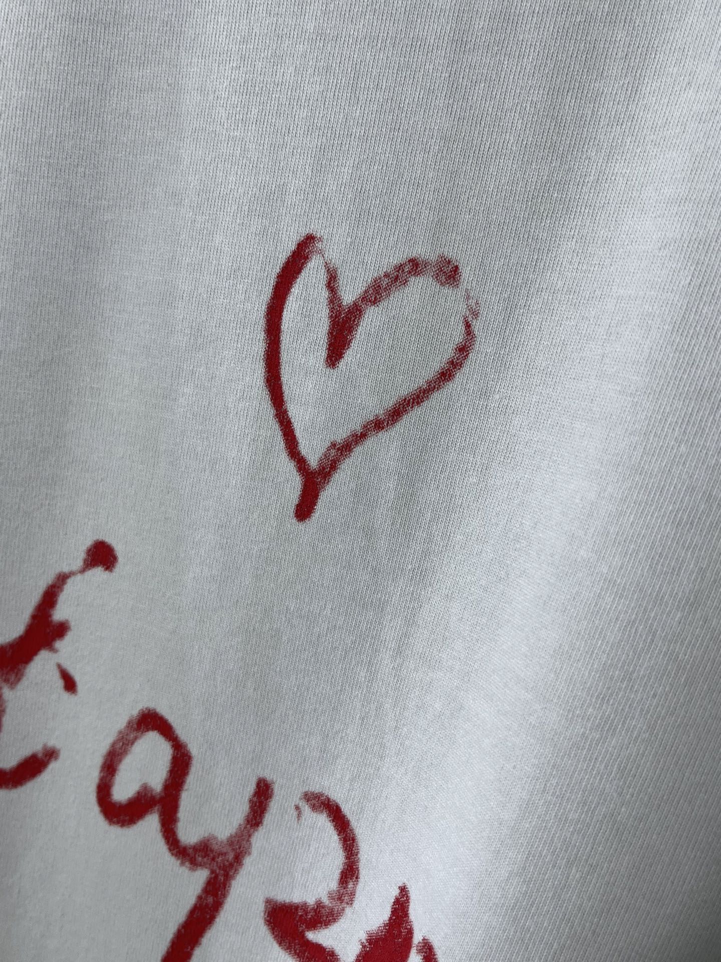 Balenciaga short-sleeve T-shirt close-up of red heart graphic on white fabric
