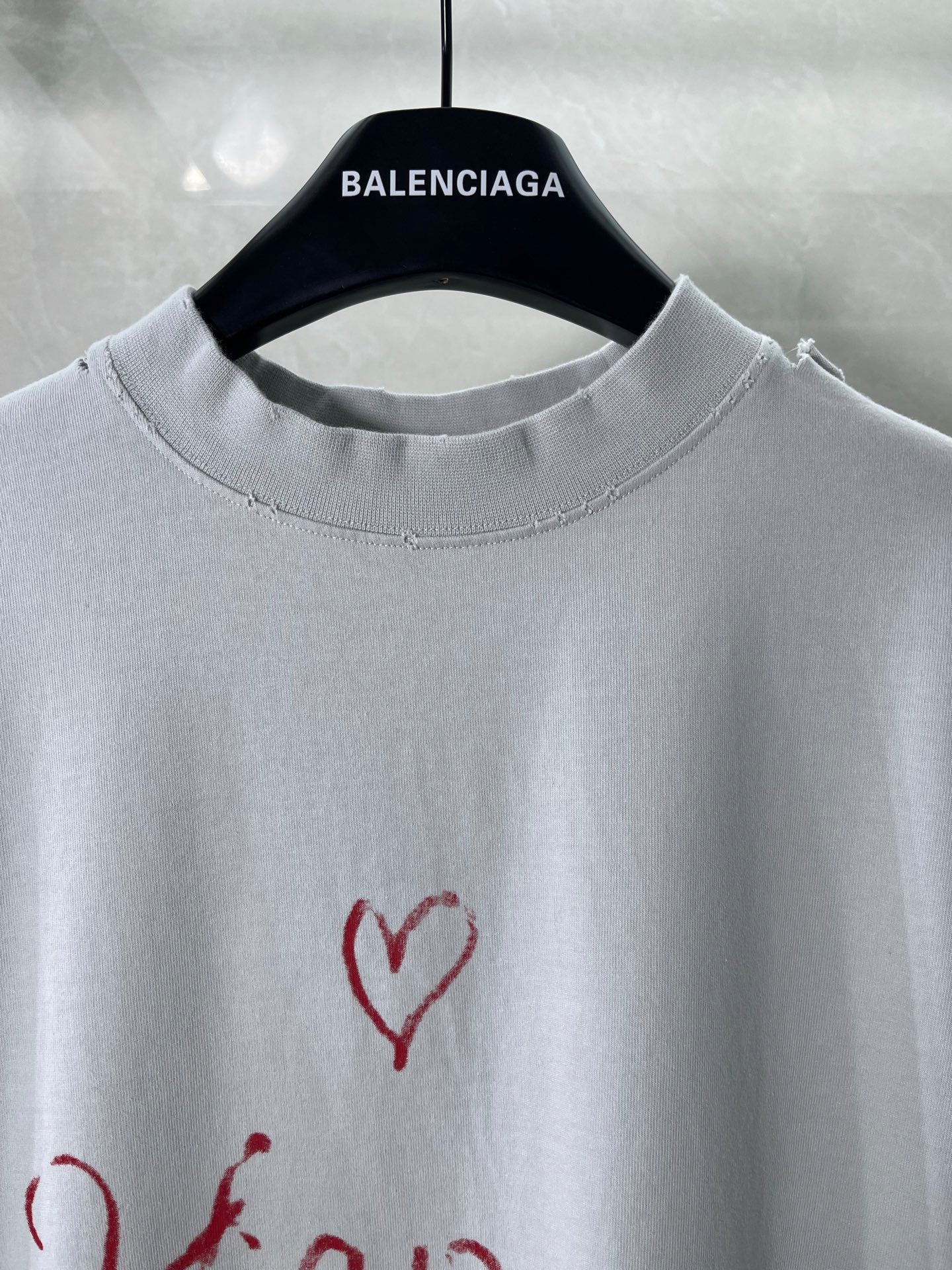 Balenciaga short-sleeve T-shirt close-up at neckline with red heart graphic