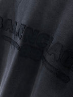 Balenciaga T-shirt close-up of embossed-style logo graphic