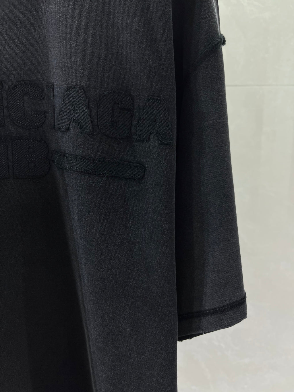 Balenciaga T-shirt with large dark logo print near front hem