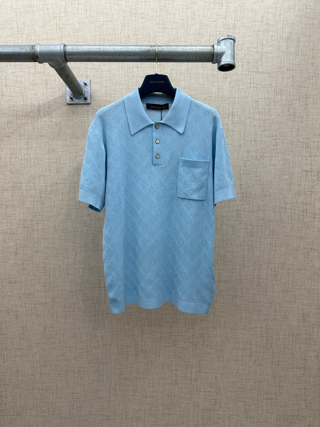 Light blue polo shirt with button placket and chest pocket