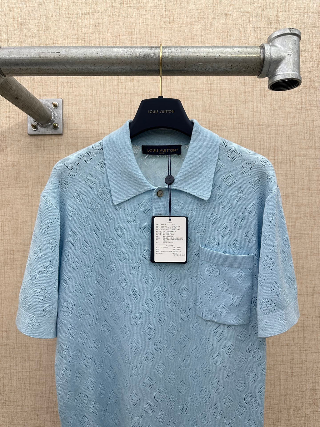 Light blue polo shirt with textured pattern, collar, and chest pocket