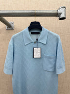 Light blue polo shirt with textured pattern, collar, and chest pocket