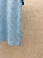 Light blue polo shirt sleeve and textured knit detail