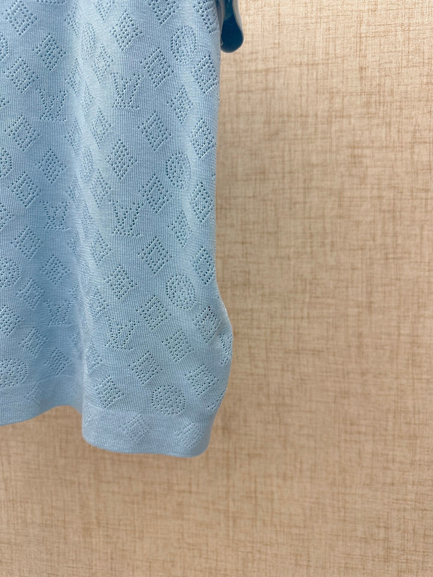 Light blue polo shirt sleeve and textured knit detail