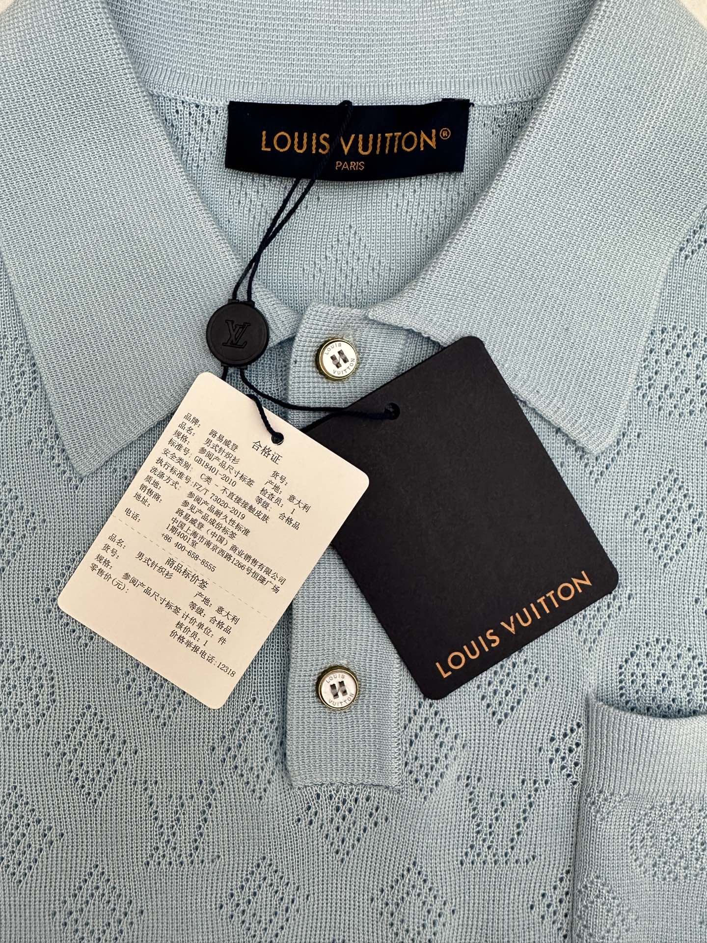 Light blue knit polo collar with Louis Vuitton care tags and buttons