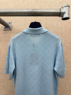 Light blue polo shirt back view with woven logo texture