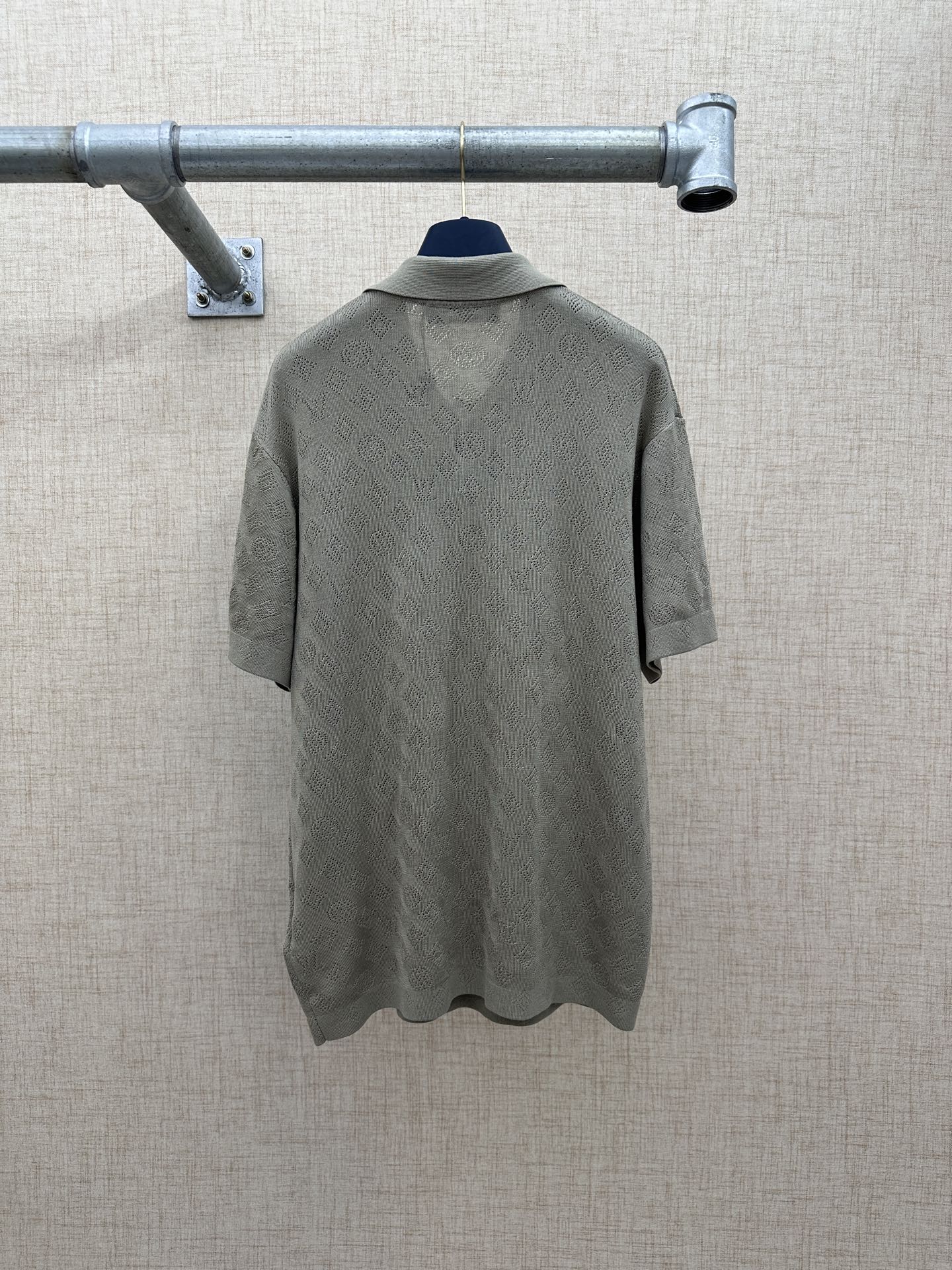 Gray short-sleeve polo shirt from back view with smooth yoke and hem