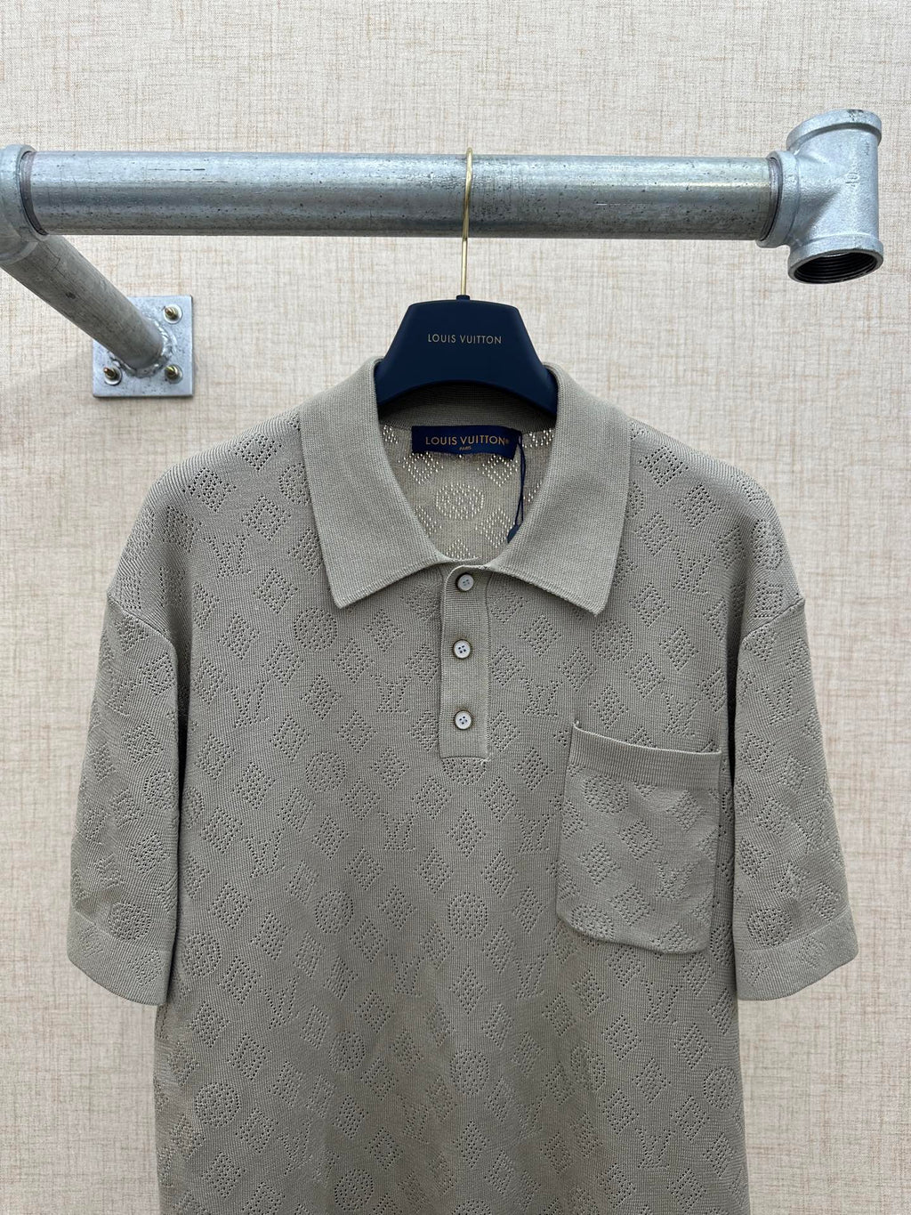 Gray short-sleeve polo shirt with textured fabric, collar, and chest pocket
