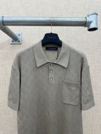 Gray short-sleeve polo shirt with textured fabric, collar, and chest pocket