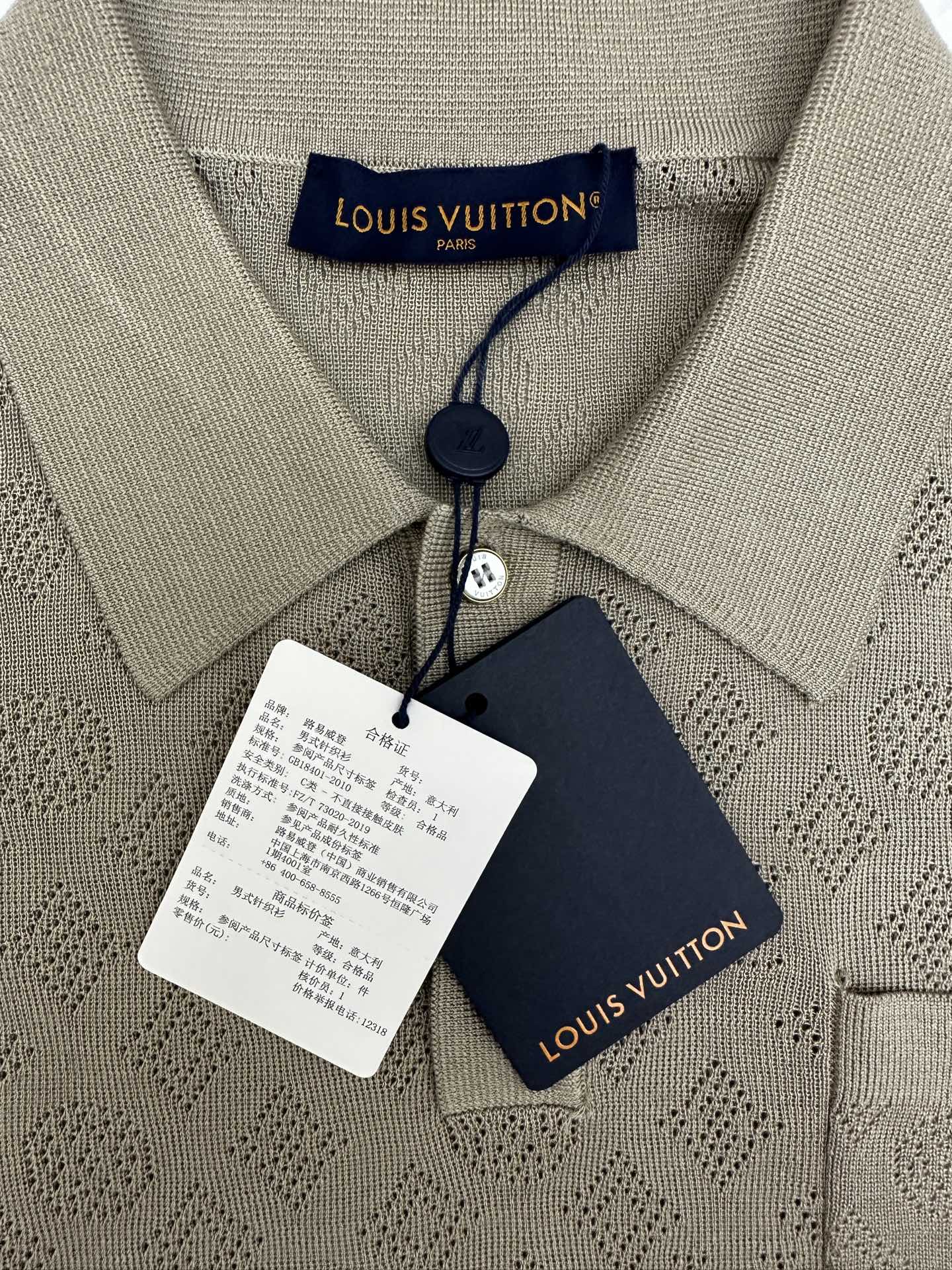 Gray polo collar with Louis Vuitton logo tag and attached price/brand labels