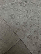 Gray polo fabric close-up showing knit pattern on fold seams