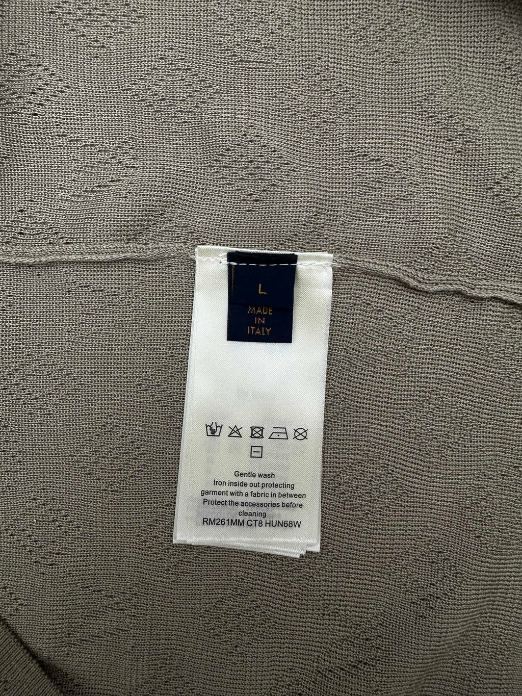 Louis Vuitton size and material tag on light gray knit polo fabric