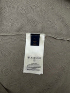 Louis Vuitton size and material tag on light gray knit polo fabric