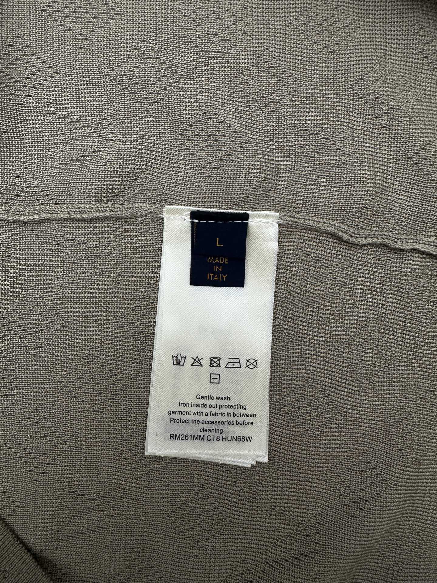 Louis Vuitton size and material tag on light gray knit polo fabric
