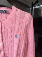 Pink cable-knit sweater with Polo logo at chest, long sleeves, button placket.