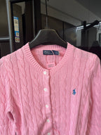 Pink cable-knit cardigan with V-neck, button front, and Polo logo patch at chest.