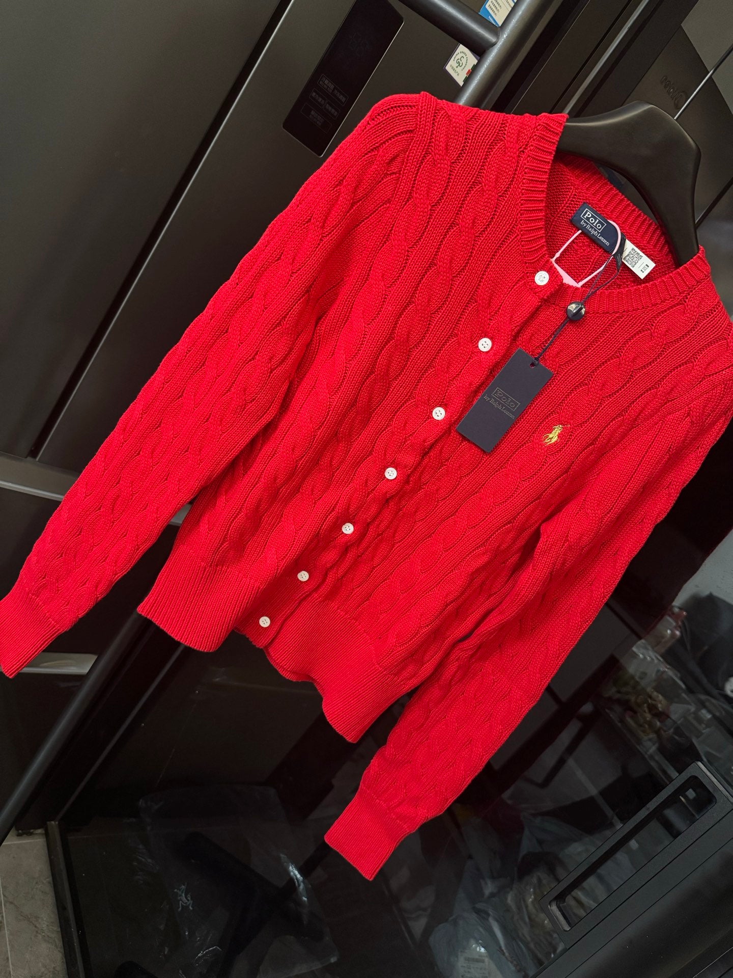Ralph Lauren cable-knit cardigan, red, angled view showing button front and polo emblem