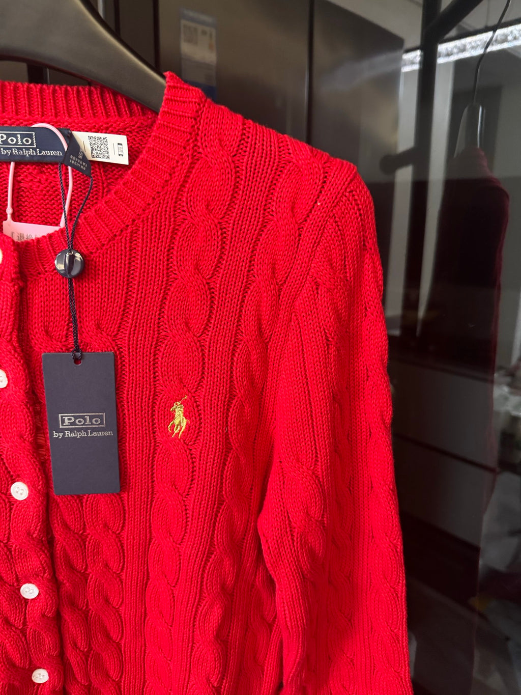 Ralph Lauren cable-knit cardigan, red, close-up of polo crest on buttoned placket