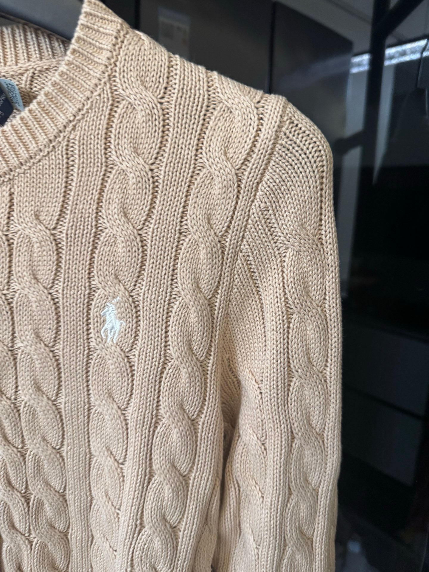 Ralph Lauren cable-knit cardigan detail, light tan knit texture, small logo embroidery