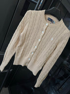 Ralph Lauren cable-knit cardigan sweater, button front, light tan, angled view