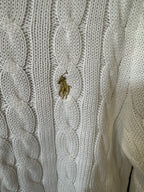 Ivory cable-knit sweater with small gold pony logo on textured knit