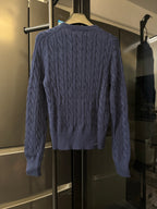 Navy cable-knit cardigan, back view, cable pattern and ribbed collar