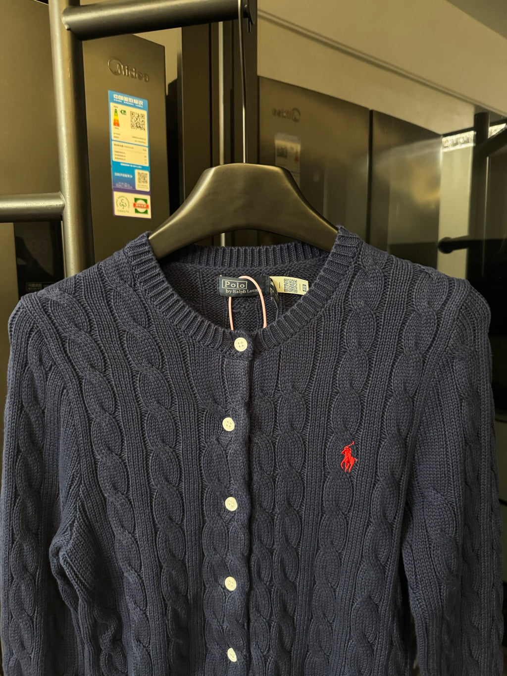 Dark gray cable-knit cardigan with button front and red polo logo