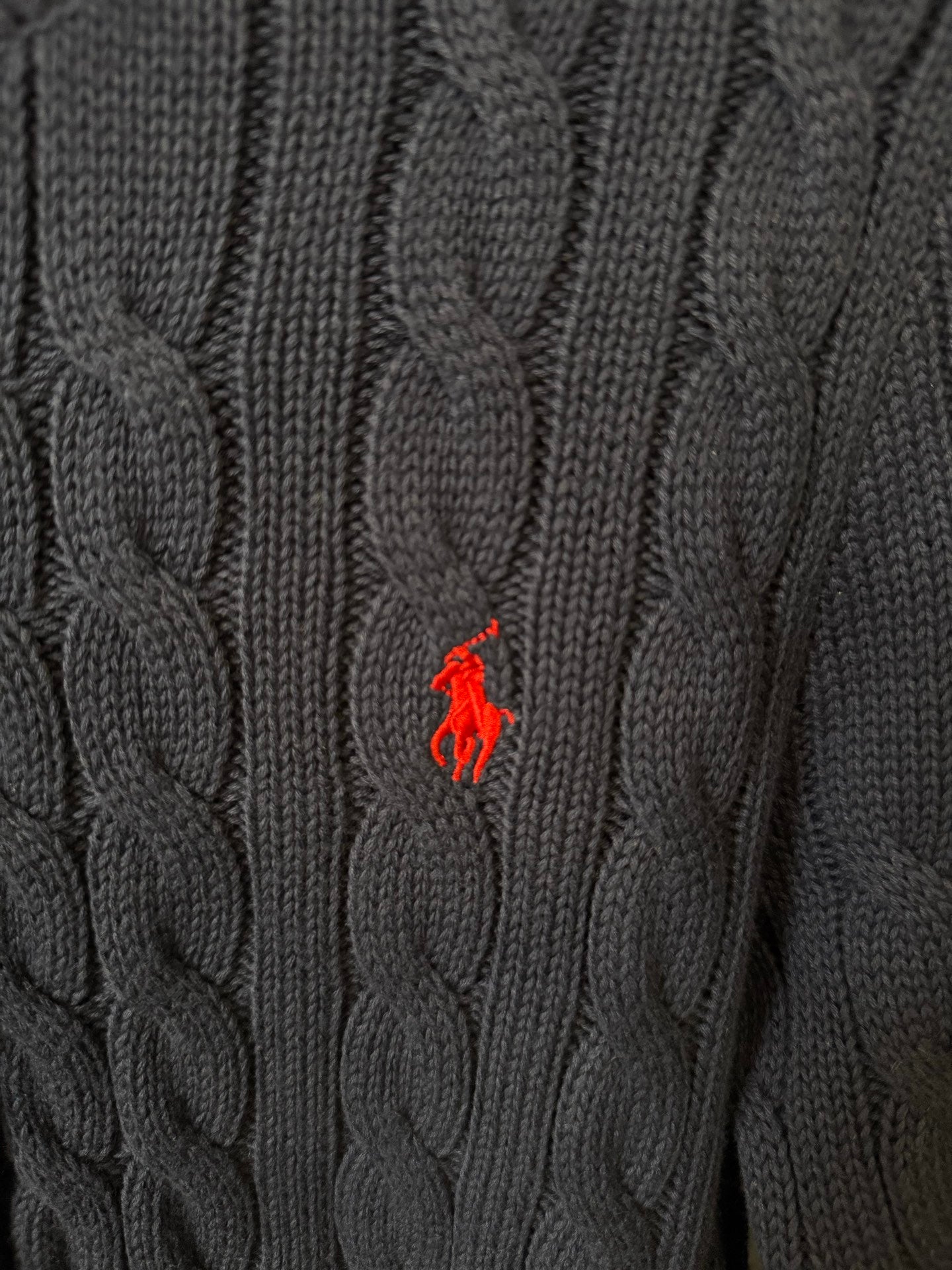 Cable-knit fabric with red polo logo