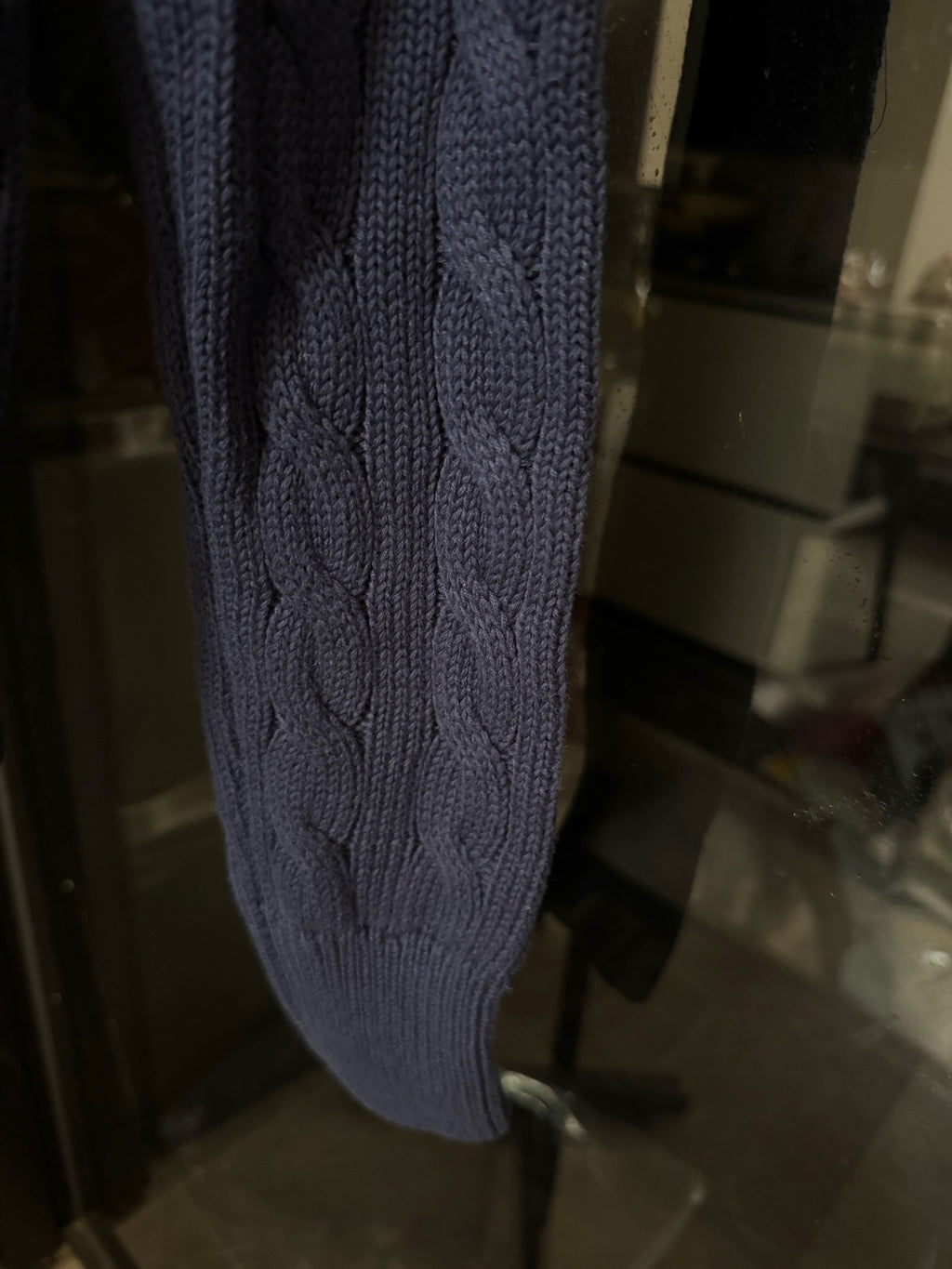 Navy cable-knit cardigan sleeve with cable pattern