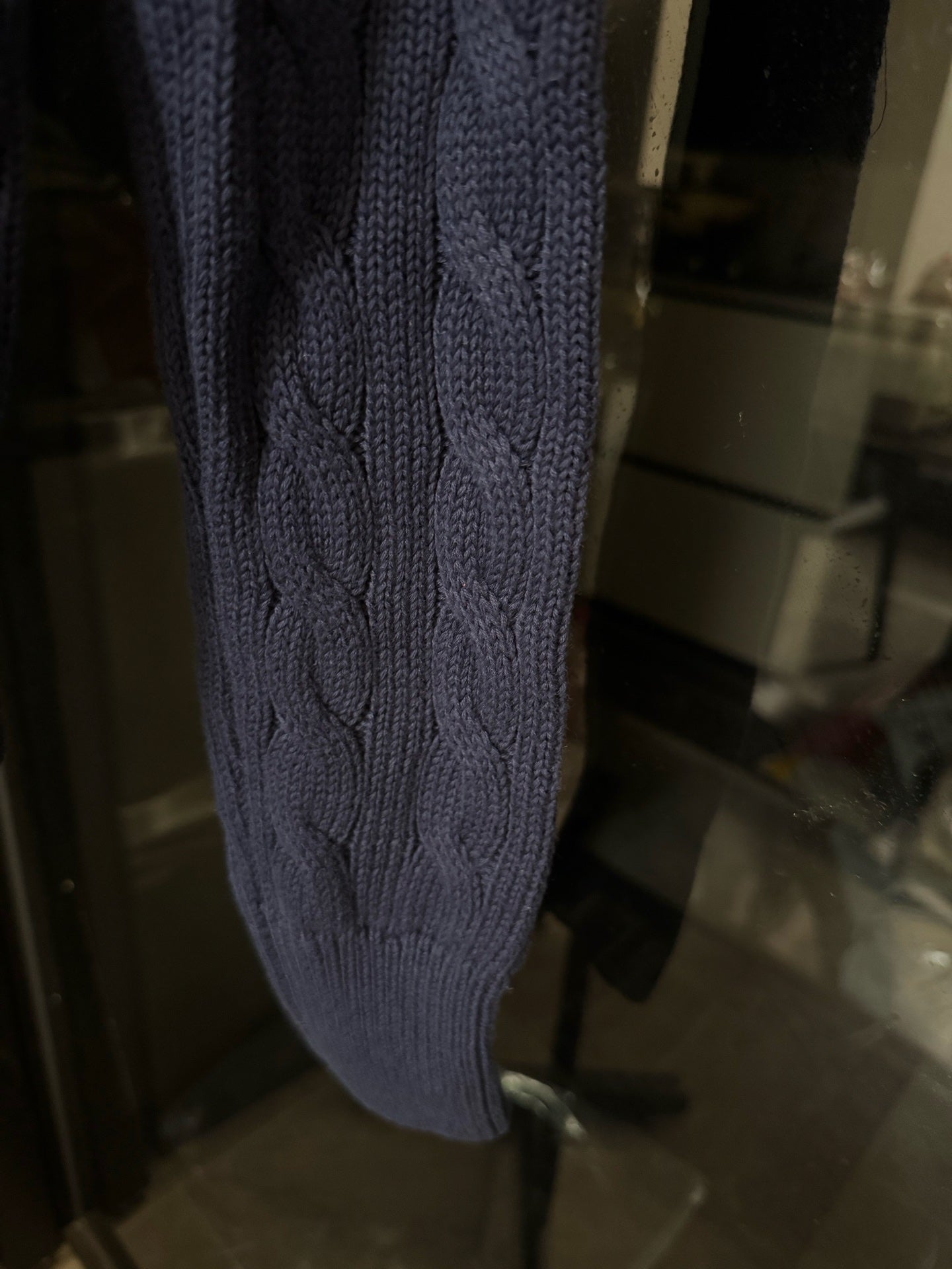 Navy cable-knit cardigan sleeve with cable pattern