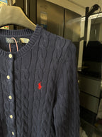 Dark gray cable-knit cardigan with red polo logo, button placket detail