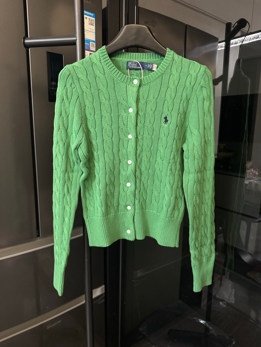 Green cable-knit cardigan with button front and small Polo logo