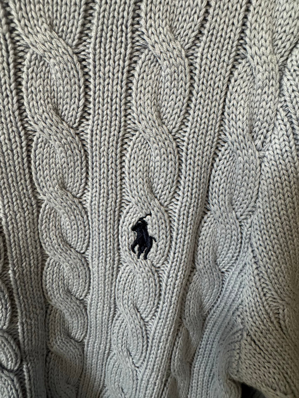 Ralph Lauren cable-knit cardigan with embroidered Polo logo on chest, cream knit.