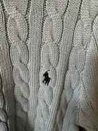 Ralph Lauren cable-knit cardigan with embroidered Polo logo on chest, cream knit.