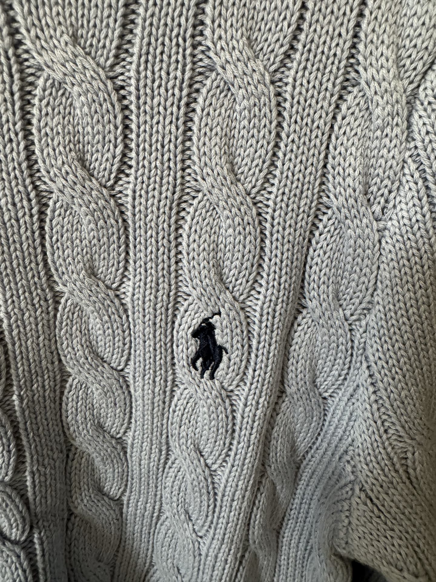 Ralph Lauren cable-knit cardigan with embroidered Polo logo on chest, cream knit.