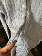 Ralph Lauren cable-knit cardigan detail, cream knit with white buttons.