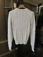Ralph Lauren cable-knit cardigan sweater, cream cable pattern on the back.