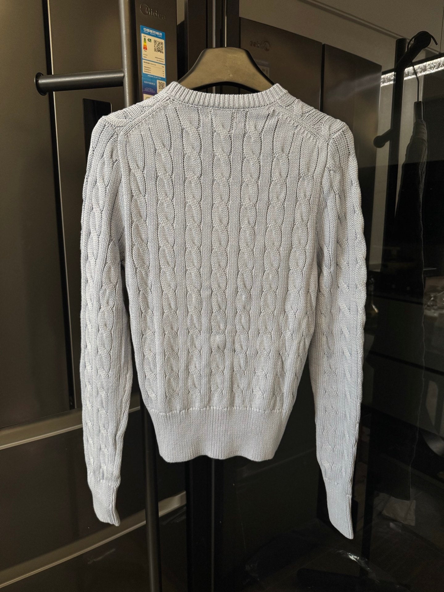 Ralph Lauren cable-knit cardigan sweater, cream cable pattern on the back.