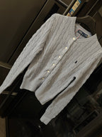 Ralph Lauren cable-knit cardigan, cream knit with button placket and Polo logo.