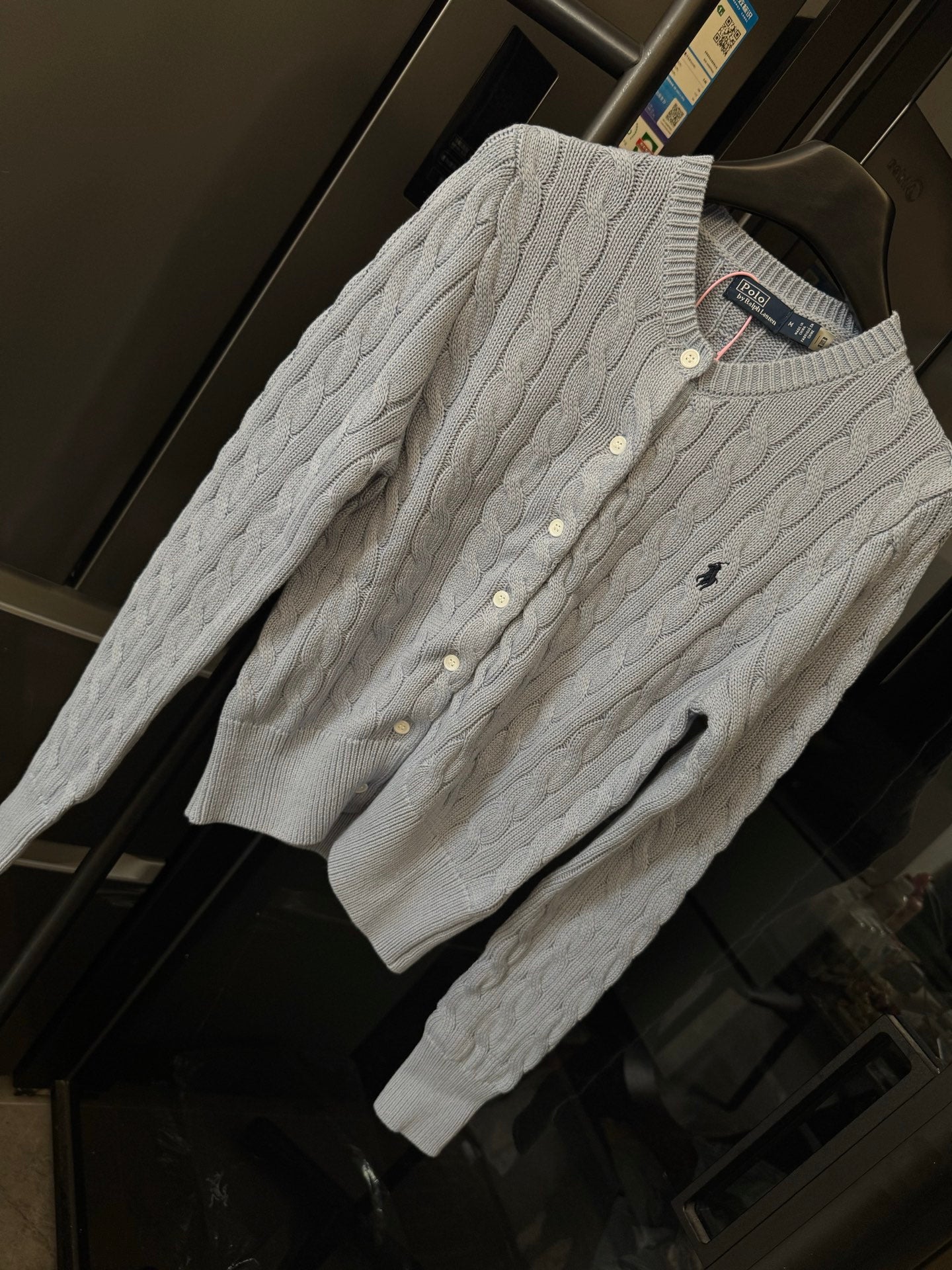 Ralph Lauren cable-knit cardigan, cream knit with button placket and Polo logo.