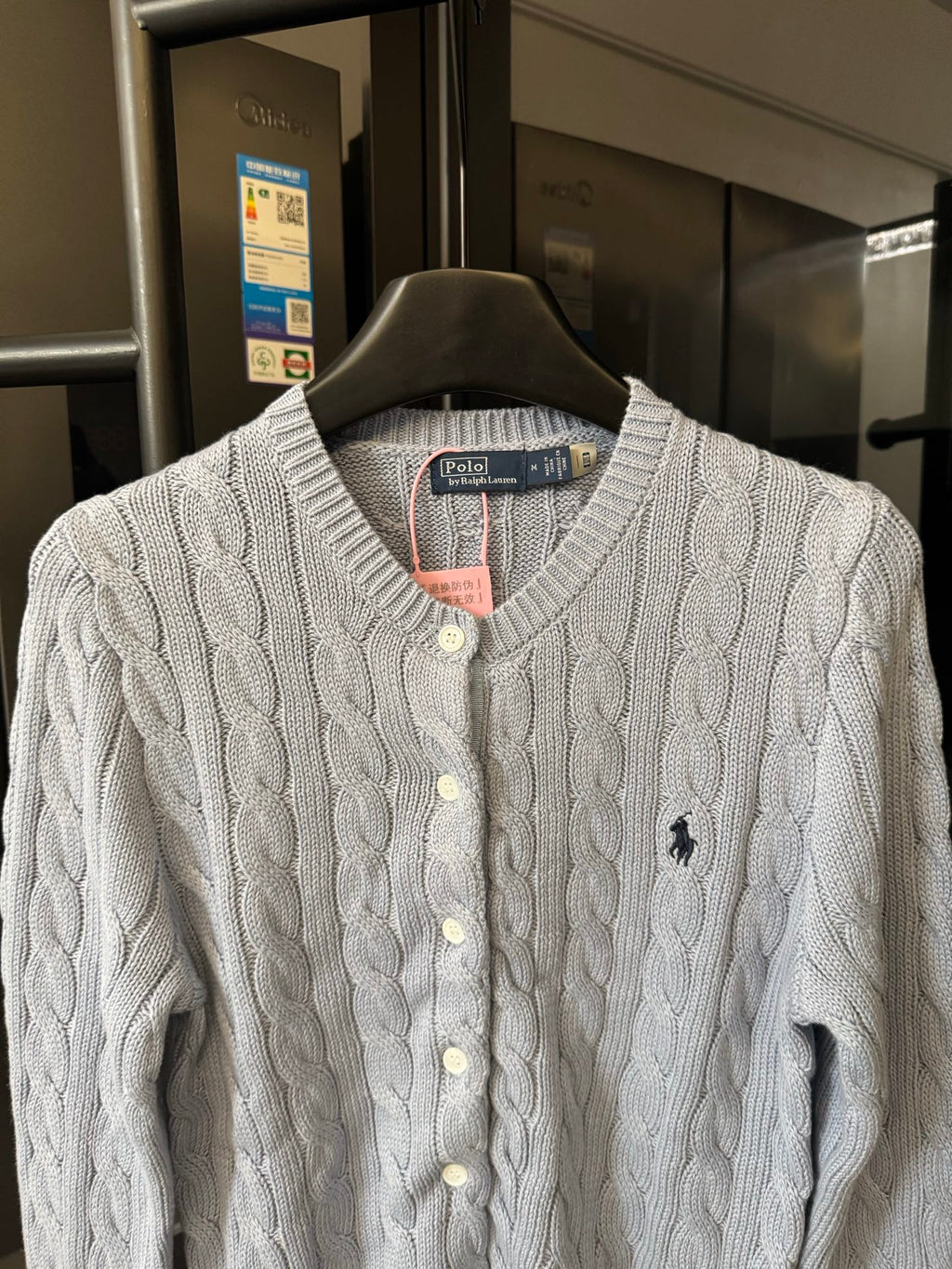 Ralph Lauren cable-knit cardigan with cream knit, button front, and embroidered Polo logo.