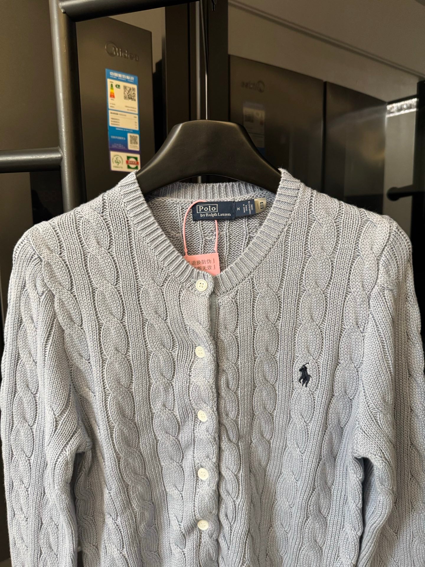 Ralph Lauren cable-knit cardigan with cream knit, button front, and embroidered Polo logo.