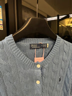 Ralph Lauren cable-knit cardigan neckline detail, light blue buttons and brand tag