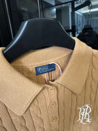 Ralph Lauren cable-knit polo shirt in beige, close-up of ribbed collar and button placket.