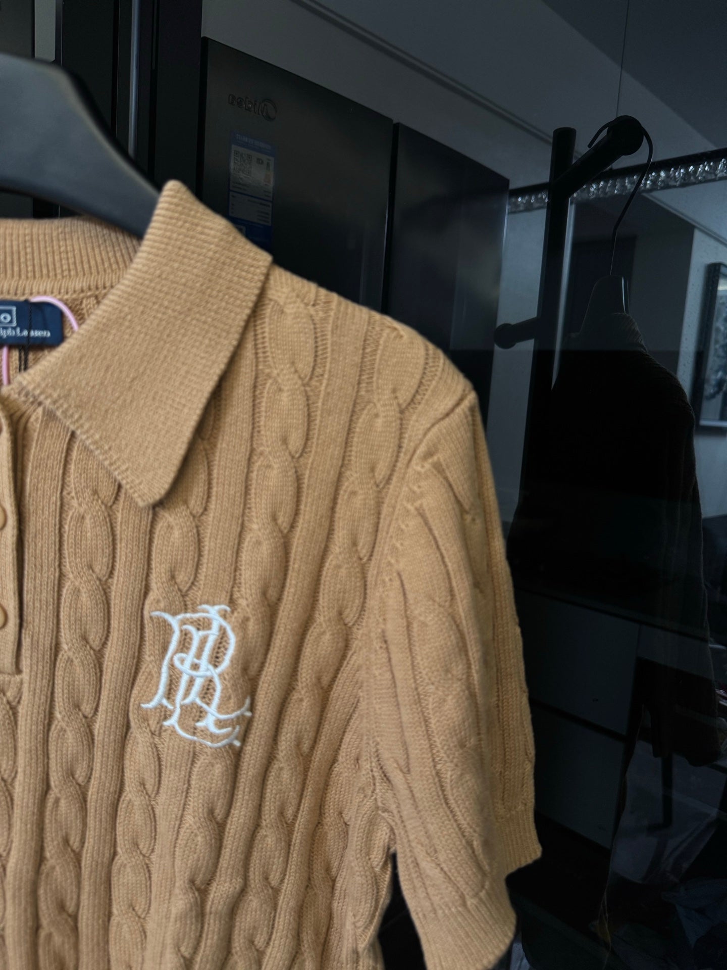 Ralph Lauren cable-knit polo shirt in beige, side view with embroidered chest logo.