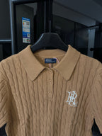 Ralph Lauren cable-knit polo shirt in beige, ribbed collar and button placket with logo.