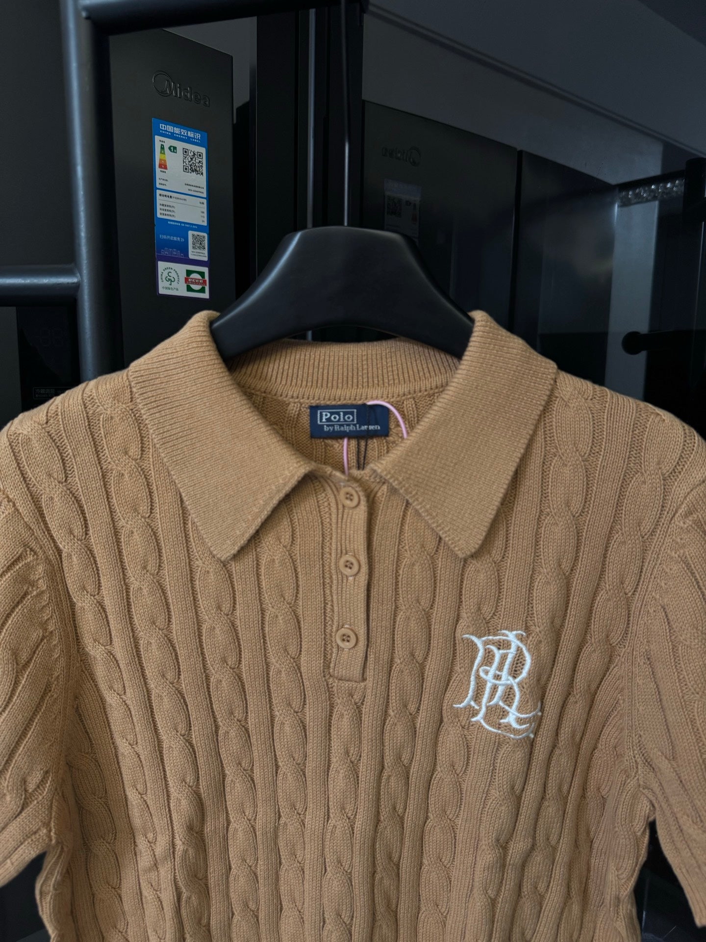 Ralph Lauren cable-knit polo shirt in beige, ribbed collar and button placket with logo.